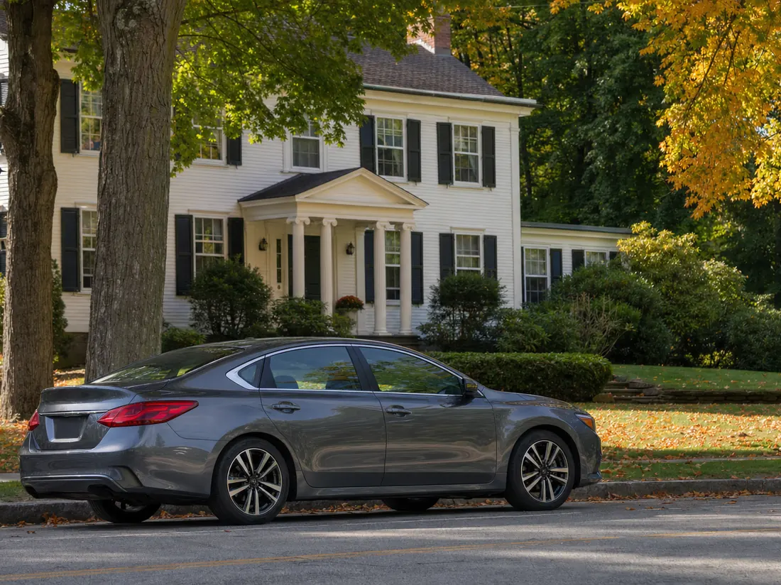 Sedan on a leafy street outside an upstate New York home - selling a car in New York