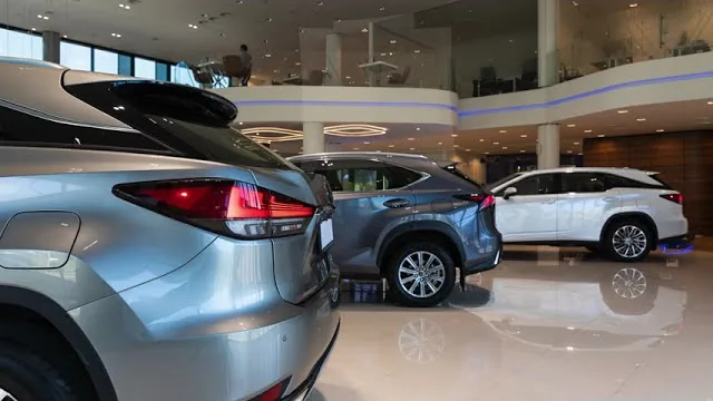 Three sport-utility vehicles on a polished showroom floor, the frame the Division's MV212 walkthrough opens on.